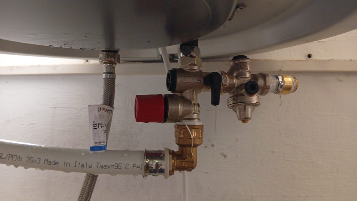 Anschlüsse und Ventile unter einem Warmwasserspeicher